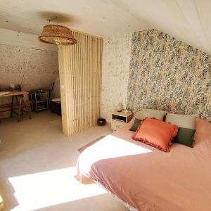 a bedroom with a bed and a desk in it at La Kabane in Fierville-les-Mines