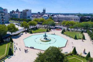 a view of a fountain in a park in a city at Bel appart Bd Foch in Angers