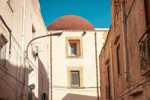 ein Gebäude mit einer Kuppel an der Straßenseite in der Unterkunft Confortevole Open Space [Centro Storico] in Marsala