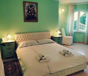 a bedroom with a large bed with two towels on it at Casa Oasa Boutique rooms Pool near Koper in Koper