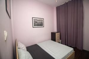 a small bedroom with a bed and a window at Ivo's 1 Bedroom Centrally Located Apartment in Sofia