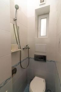 a white bathroom with a shower and a toilet at Ivo's 1 Bedroom Centrally Located Apartment in Sofia