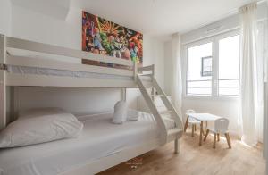 a white bedroom with a bunk bed and a desk at Disneyland-Paris 11pers, 2parkings, Wifi, in Chessy +28 photos