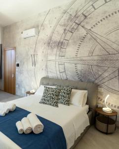 a bedroom with a bed with a mural on the wall at Cinque Venti BB Porto Cesareo in Porto Cesareo