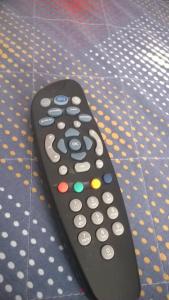 a remote control sitting on a polka dot blanket at Bed Il Faro in Finale Ligure