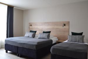 a hotel room with two beds and a window at Hotel Hvolsvollur - Central South Iceland in Hvolsvöllur