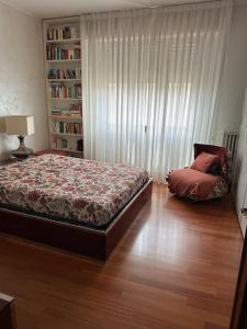 a bedroom with a bed and a book shelf at La Casa di Sandra 6km da Firenze in Sesto Fiorentino