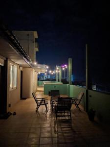a group of chairs sitting on a patio at night at Palmyrah Residencies in Colombo
