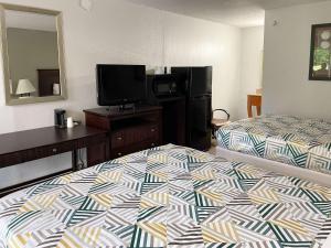 a hotel room with a bed and a flat screen tv at Motel 6 Wytheville VA in Wytheville