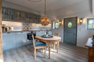 uma cozinha com uma mesa de madeira e uma sala de jantar em Nannings Huis em Oevenum