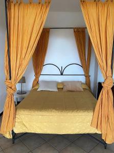 a bedroom with a large bed with curtains at Agriturismo Gianferrante in Paterno