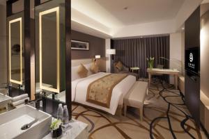 a hotel room with a bed and a bathroom at Northern Hotel Shanghai in Shanghai
