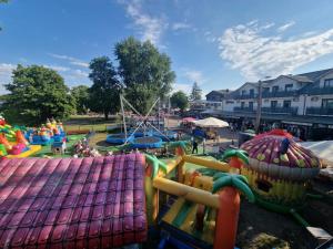 a park with a playground with a roller coaster at Ośrodek Promenada- Domki in Jastrzębia Góra