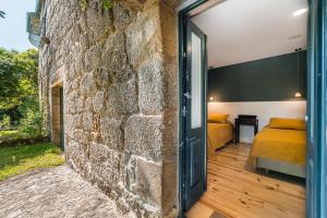 a room with a stone wall and a bedroom at Stone-crafted tranquility with a relaxing pool in Taide