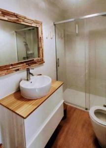 a bathroom with a sink and a shower and a toilet at El Cotillo On The Beach by Momi Fuerteventura in Cotillo