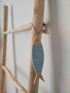 a piece of wood hanging on a wall at El Cotillo On The Beach by Momi Fuerteventura in Cotillo