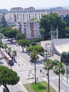 an aerial view of a city street with a bus at new private room ,sea view, near airport 5 min, train 3 min and tram on site, beach 7 min, 2 showers and 2 toilets. Neuf , chambre privative, vue mer, proche aéroport 5 min , train 3 min et tramway sur place, plage 7 min, 2 douches et 2 wc. in Nice