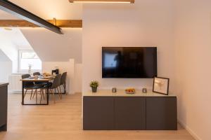 a living room with a tv on the wall at Zur alten Bäckerei 