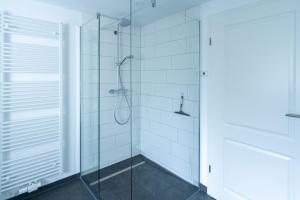 a bathroom with a shower with a glass door at Zur alten Bäckerei 