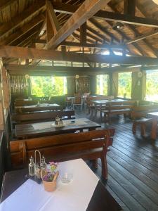a room with tables and benches in a building at NO COMMENT RUSTIC in Curtea de Argeş