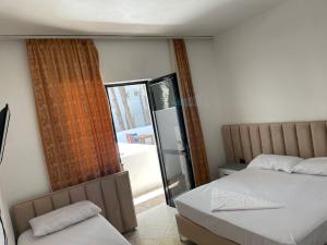 Postel nebo postele na pokoji v ubytování Hotel Ani