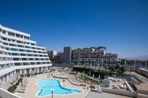 a resort with a swimming pool and a hotel at YalaRent New Sea side resort apartments in Eilat