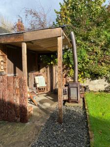 a woodburning stove in a backyard with a shed at The Pig and Sty in Hereford +19 photos