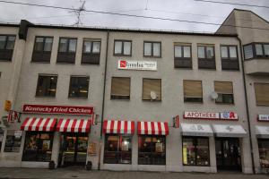 a building with a bunch of shops on a street at Slamba Hostel in Augsburg