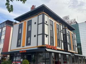 a building with a sign on the front of it at TAN OTEL in Mersin