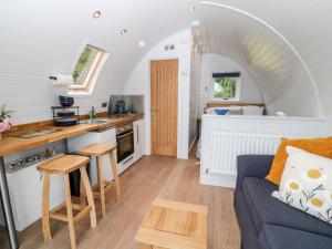a kitchen and living room in a tiny house at Oak in Saltash