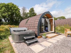a small dome house with a hot tub in the yard at Oak in Saltash