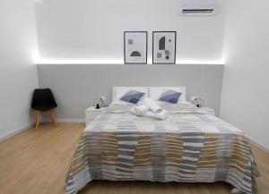 a bedroom with a large bed with blue pillows at A CANTUNERA in Balestrate