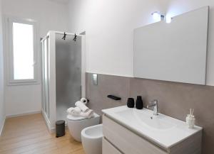 a bathroom with a white sink and a toilet at A CANTUNERA in Balestrate +6 photos