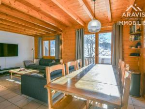 a dining room with a table and a living room at Chalet Le Grand-Bornand, 5 pièces, 8 personnes - FR-1-391-158 in Le Grand-Bornand