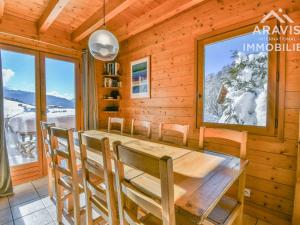 a dining room with a wooden table and chairs at Chalet Le Grand-Bornand, 5 pièces, 8 personnes - FR-1-391-158 in Le Grand-Bornand