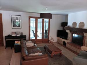 uma sala de estar com um sofá e uma lareira em Villa avec piscine privée proche Bandol/Beausset em Le Beausset