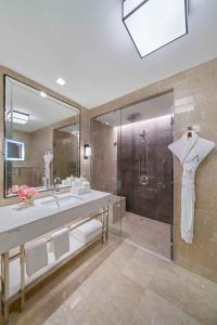 a bathroom with a large sink and a shower at Address Jabal Omar Makkah in Makkah