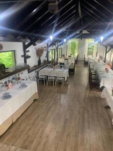 a dining room with white tables and chairs at NO COMMENT RUSTIC in Curtea de Argeş