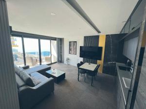 a living room with a couch and a table at Traumhaftes Apartment mit Privatstrand, Sea View, Pool, Sauna, Gym, Playground in erster Reihe, Alanya-Mahmutlar in Alanya