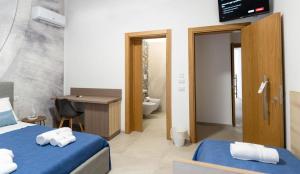 a hotel room with two beds and a bathroom at Cinque Venti BB Porto Cesareo in Porto Cesareo +70 photos