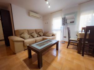 a living room with a couch and a table at APARTAMENTO AL-ALBA in Córdoba