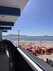 a view of a beach with umbrellas and the ocean at Pousada Hoffmann in Florianópolis