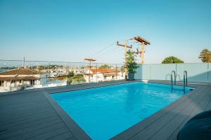 a swimming pool on the roof of a building at Daedalus Luxury Home - Seaview & Heated Pool in Kontokali