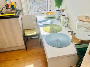 a kitchen with a counter with plates on it at Very Lovely and Central 1-Bed Apartment in London in London