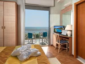 Posteľ alebo postele v izbe v ubytovaní Hotel Corallo