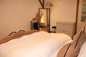 a bedroom with a white bed and a mirror at Oak Cottage - Near Abergavenny in Abergavenny