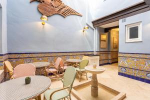 a restaurant with tables and chairs and a star on the wall at Casa de Alma in Málaga