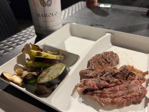a plate of food with meat and vegetables on a table at KAI Ichinomiya in Ichinomiya