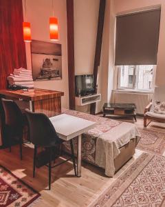 a room with a bed and a desk and a television at New Pera Hotel in Istanbul