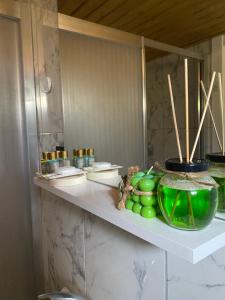 a shelf with a bowl of green apples on it at Vayu Hotel&Tiny Houses in Canakkale